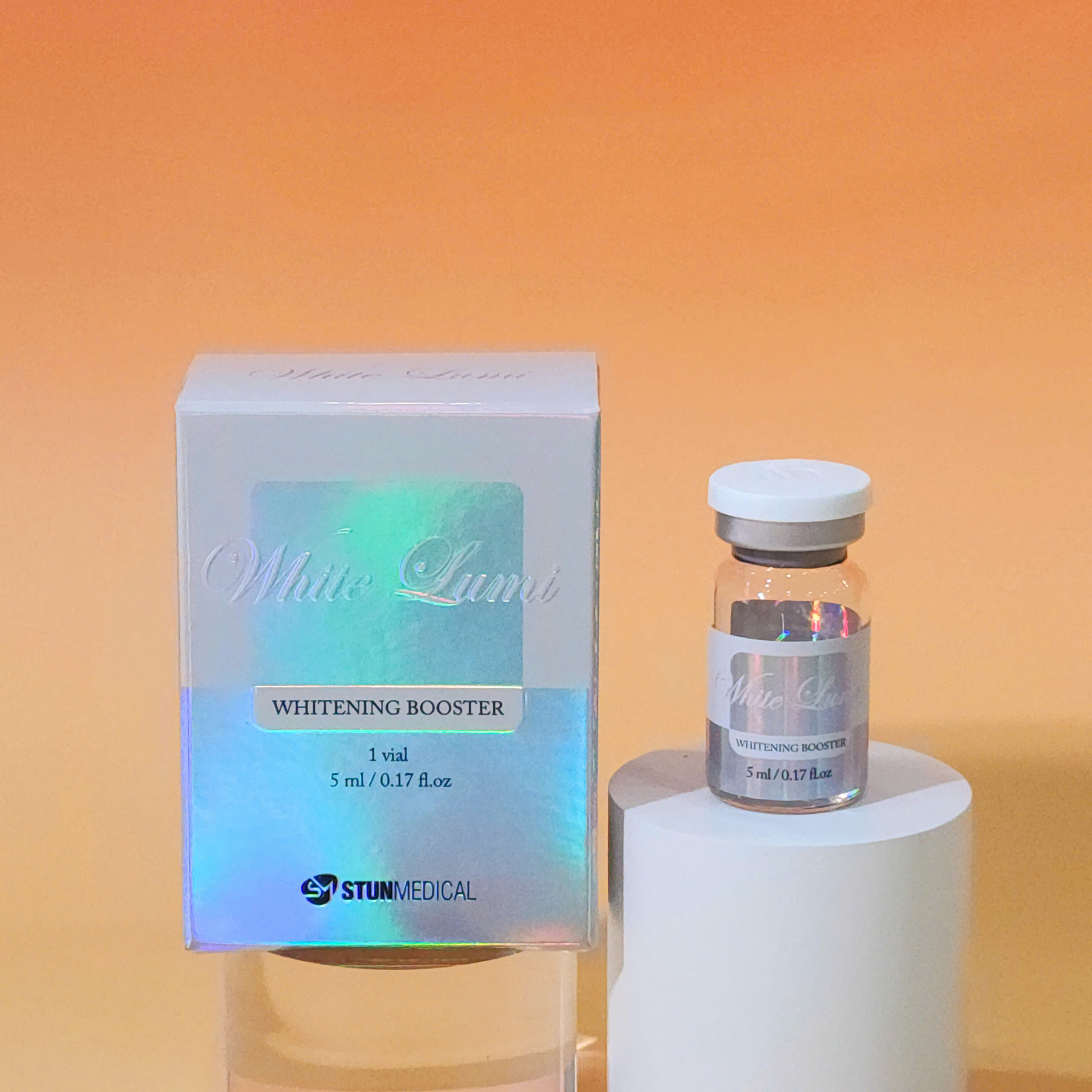 Whitening booster vial and packaging on a white pedestal against an orange background